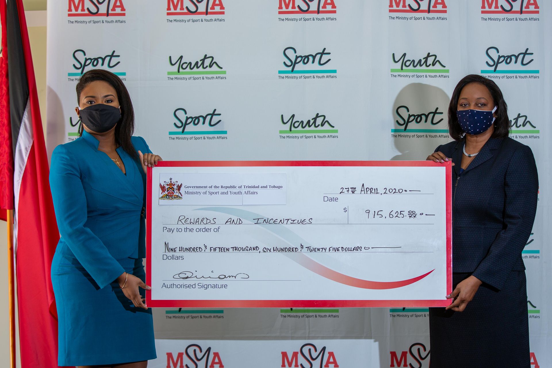 Sports and Youth Affairs Minister Shamfa Cudjoe and Permanent Secretary Claire Davidson-Williams sports the cheque for the Rewards and Incentives Programme. Cheques for different sums were distributed to several T&T athletes on Wednesday.  Kerron Savory