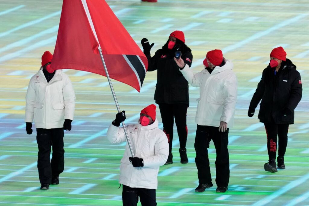 TT bobsledder Andre Marcano carries the national flag during the opening ceremony of the 2022 Winter Olympics, on Friday, in Beijing. - (AP PHOTO)