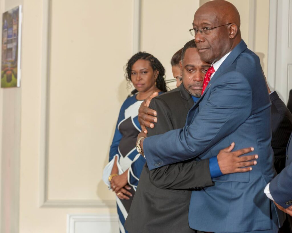 CONSOLED: Prime Minister Dr Keith Rowley consoles Kelvin a weeping Bhagwandeen who received the Hummingbird Medal (Bronze) on behalf of his daughter Rachel, 11, who died while saving her younger brother from a dog attack in August 2022. The national awards ceremony was held on Sunday at President's House. Photo courtesy the Office of the President - (Image obtained at newsday.co.tt)