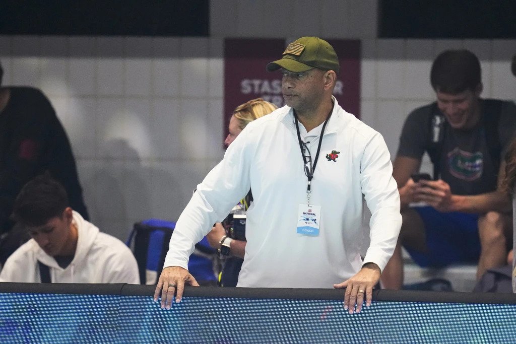 FILE - Coach Anthony Nesty watches as swimmers warm up at the U.S. nationals swimming meet in Indianapolis, June 27, 2023. Nesty made more history Thursday, Sept. 21, when he was picked to lead the U.S. men’s swimming team in Paris, where he will become the first Black head coach for the powerhouse American squad at the Olympics. Nesty’s selection was announced by USA Swimming, which also appointed Todd DeSorbo to head the women’s squad next summer. (AP Photo/Michael Conroy, File) (Image obtained at tt.loopnews.com)