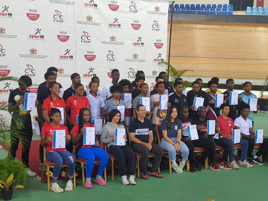 ALL TOGETHER: Cyclists and their instructors pose for a group photo during the closing ceremony of the Union Cycliste Internationale (UCI) Road and Track Training Camp held at the UCI Satellite Centre at the National Cycling Centre in Balmain, Couva, on Friday. (Image obtained at trinidadexpress.com)